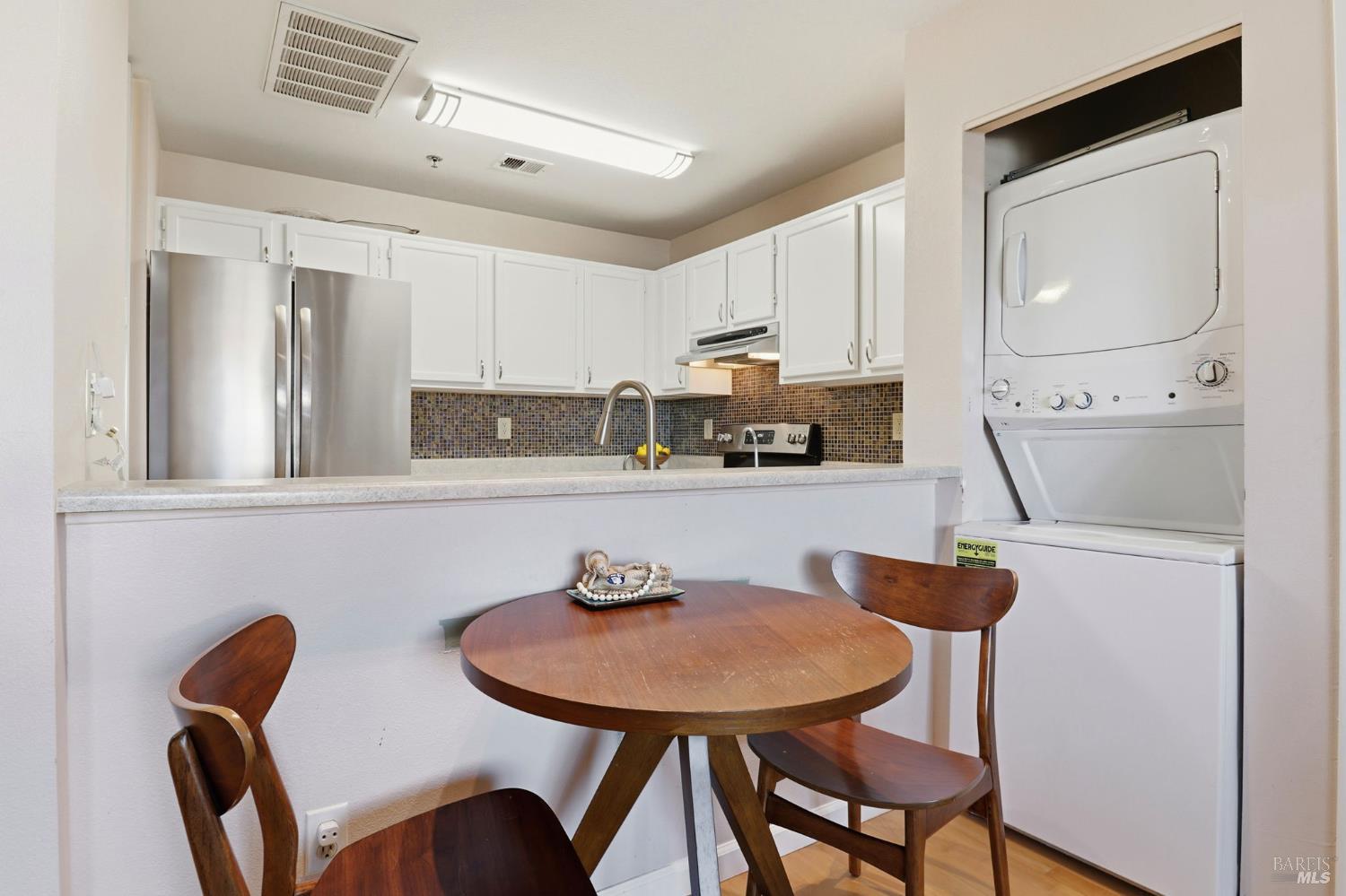 240 Seagull Row Novato, CA 94945 - Photo 13 of 33 a kitchen with stainless steel appliances a dining table and chairs
