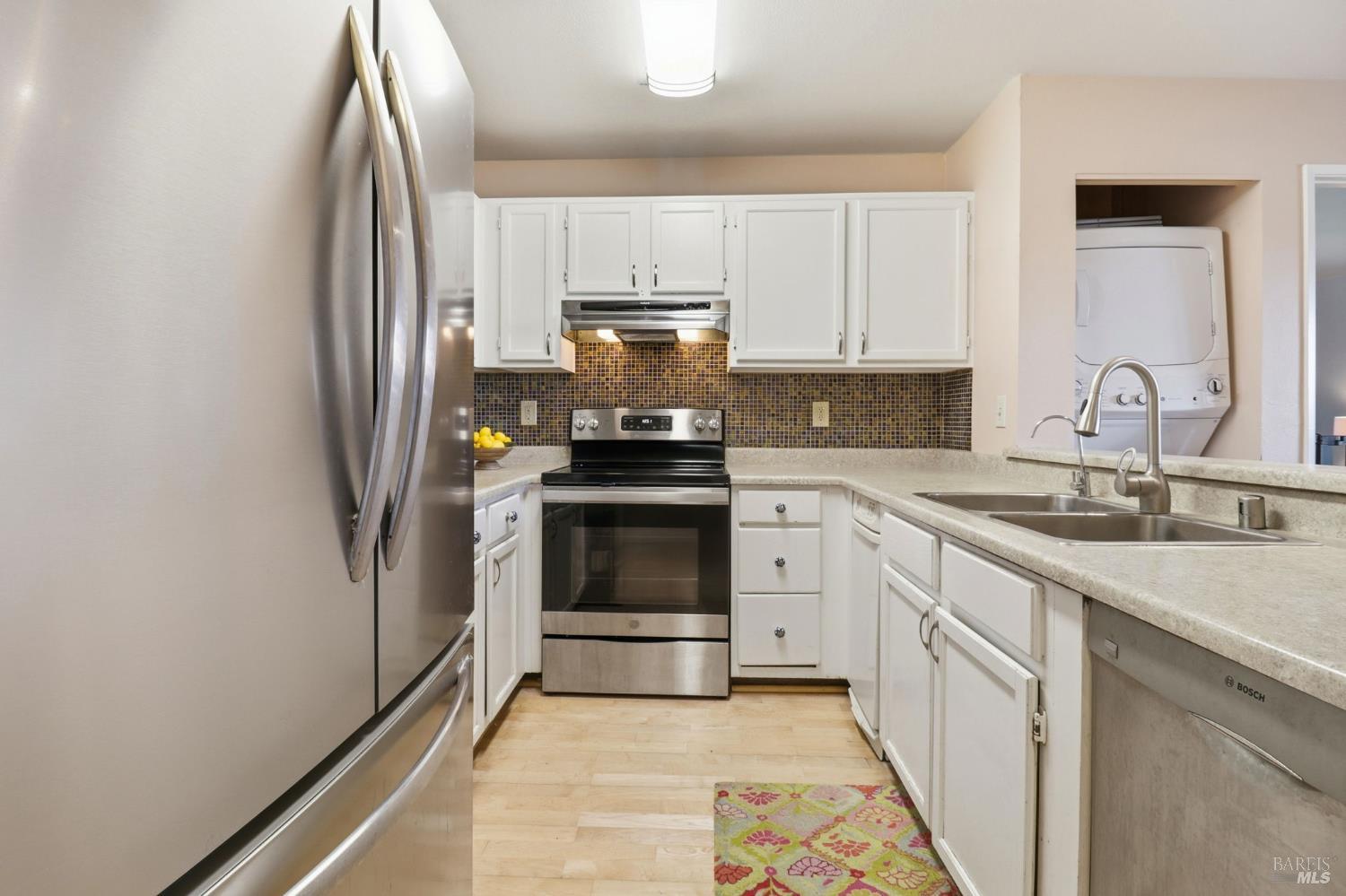 240 Seagull Row Novato, CA 94945 - Photo 15 of 33 a kitchen with granite countertop a refrigerator stove and sink