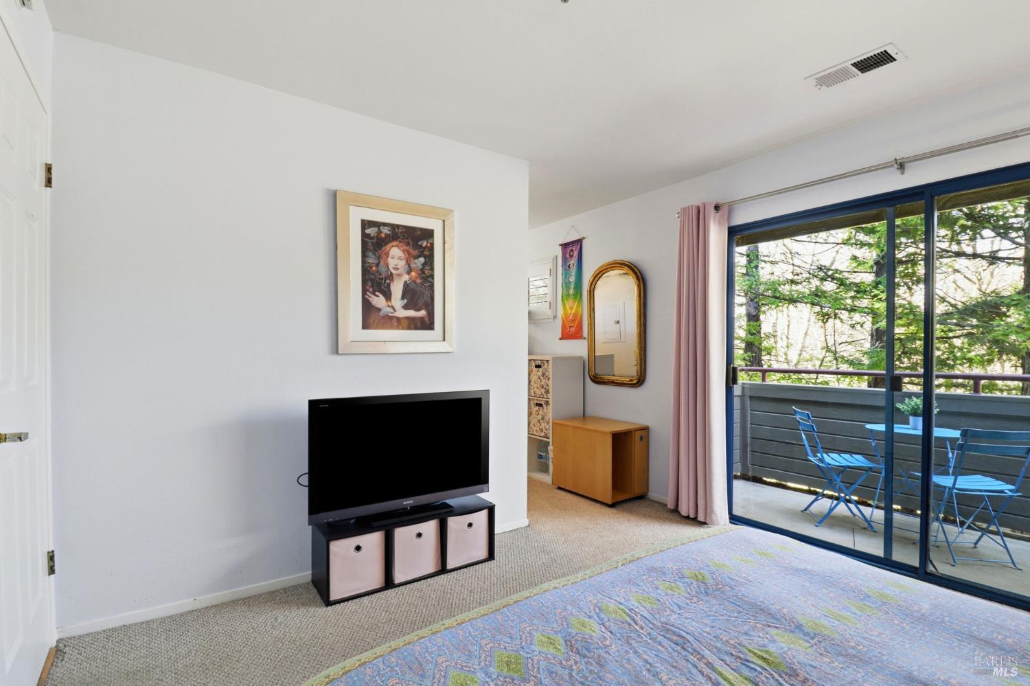 240 Seagull Row Novato, CA 94945 - Photo 21 of 33 a living room with furniture a flat screen tv and a floor to ceiling window