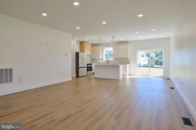 a view of a kitchen with a sink an oven and cabinets