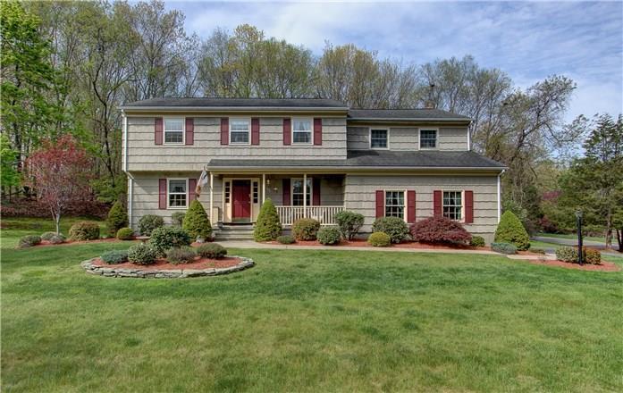35 Deep Gorge Road Trumbull, CT 06611 - Photo 1 of 1 a front view of a house with a garden and trees