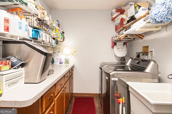 a utility room with sink dryer and washer