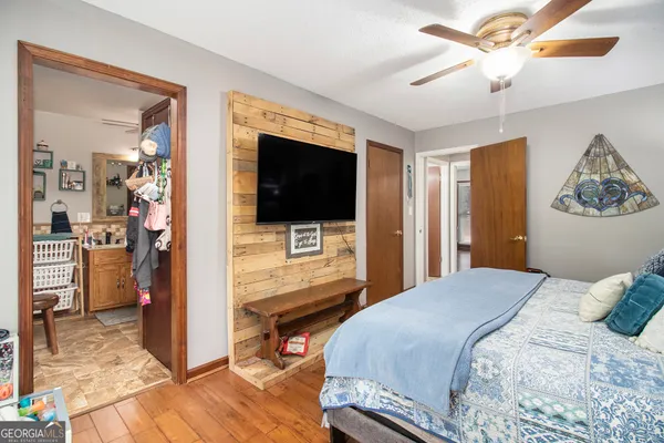 a bedroom with a bed and a flat screen tv