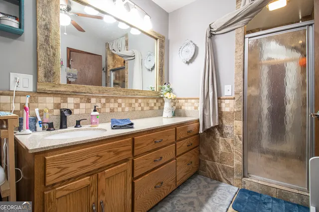 a bathroom with a sink vanity and a mirror