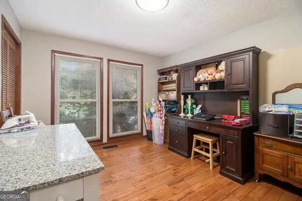 a living room with hardwood floor and ceiling fan