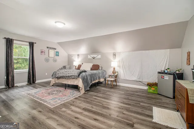 a bedroom with furniture and a wooden floor