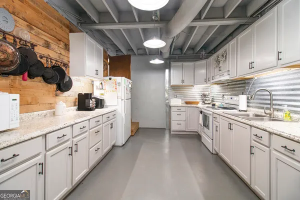 a white refrigerator freezer sitting inside of a kitchen