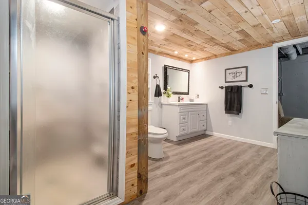 a bedroom with a bed next to a window