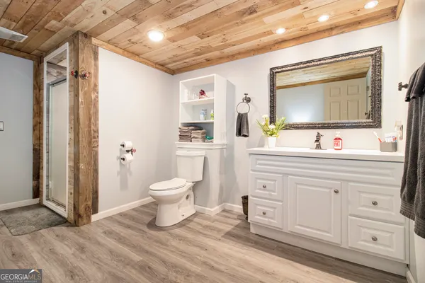 a view of a house with a small yard and wooden fence