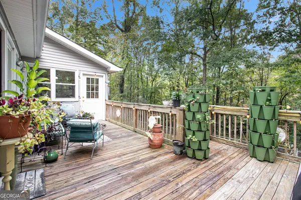 a view of a house with a small yard and sitting area