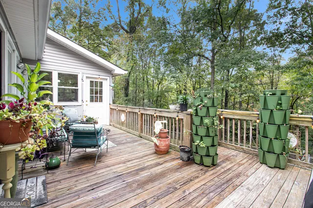 a view of a house with a small yard and sitting area