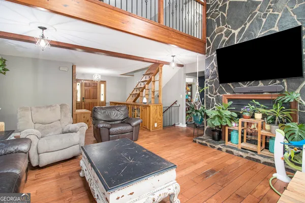 a living room with furniture and a flat screen tv