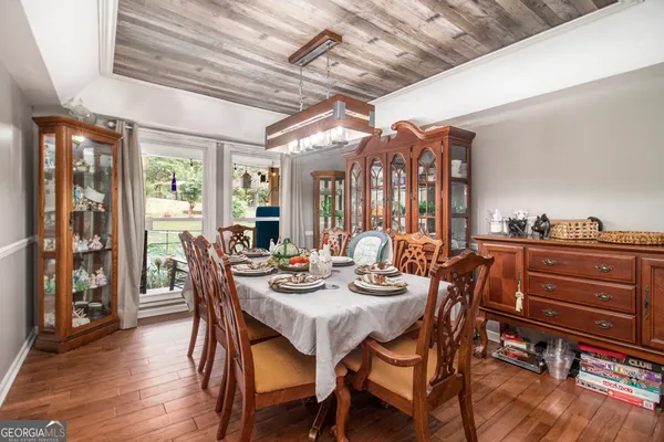 a view of a dining room with furniture window and wooden floor