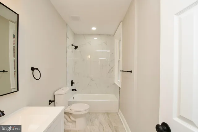a bathroom with a toilet a sink and a bathtub