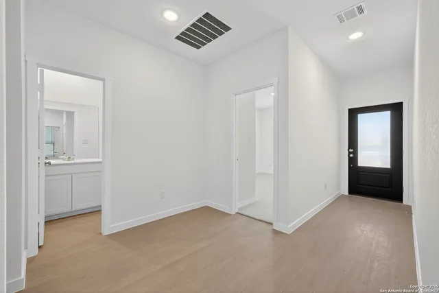 an empty room with windows and closet