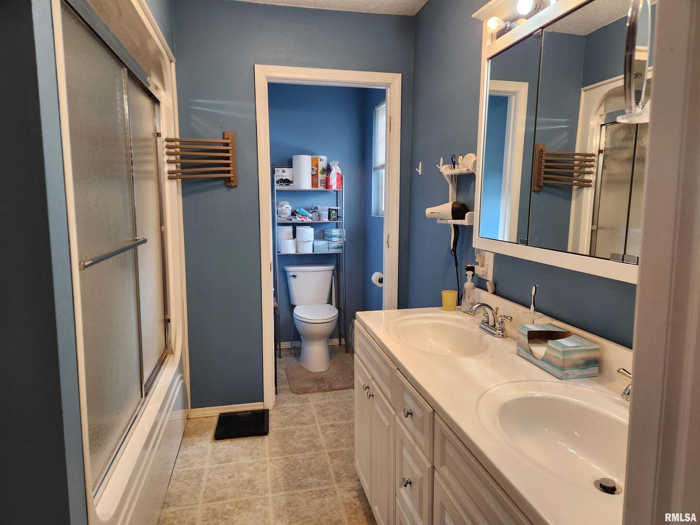 15766 East Tilton Road Ina, IL 62846 - Photo 15 of 59 a bathroom with a sink toilet and shower