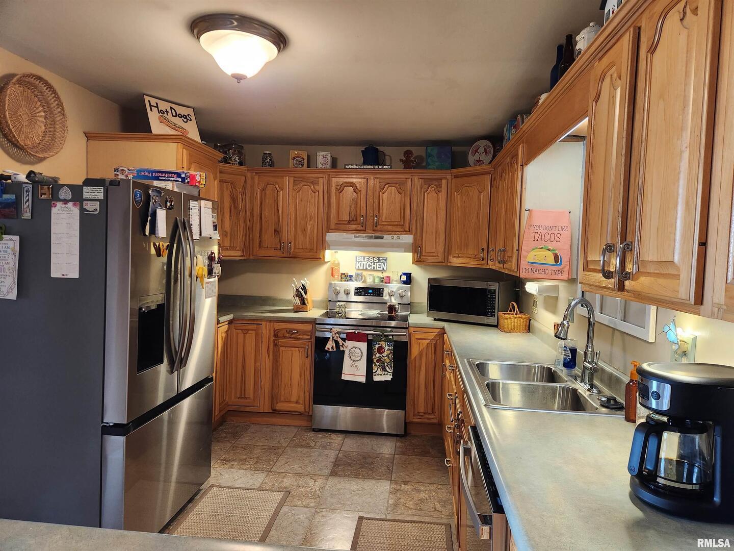 15766 East Tilton Road Ina, IL 62846 - Photo 21 of 59 a kitchen with stainless steel appliances granite countertop a sink a stove and a refrigerator