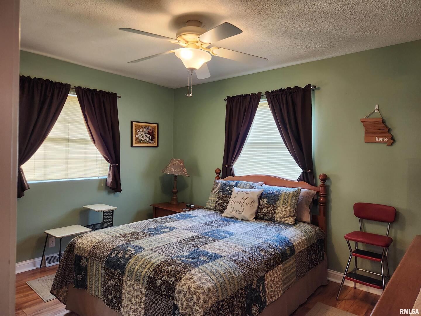 15766 East Tilton Road Ina, IL 62846 - Photo 25 of 59 a bedroom with a bed and a painting on the wall