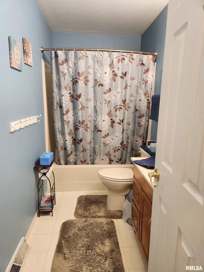 15766 East Tilton Road Ina, IL 62846 - Photo 33 of 59 a bathroom with a toilet and a shower curtain