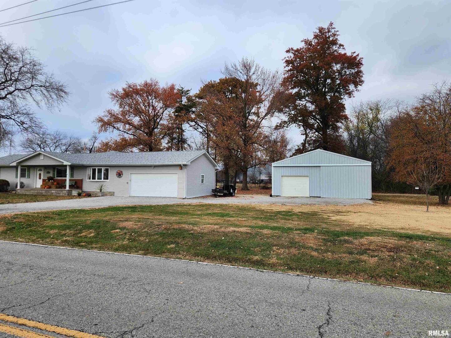 15766 East Tilton Road Ina, IL 62846 - Photo 50 of 59 a front view of a house with a yard and garage