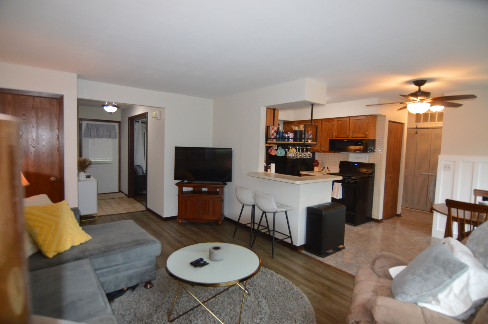 730 Nantucket Way Island Lake, IL 60042 - Photo 12 of 29 a living room with furniture a flat screen tv and kitchen view