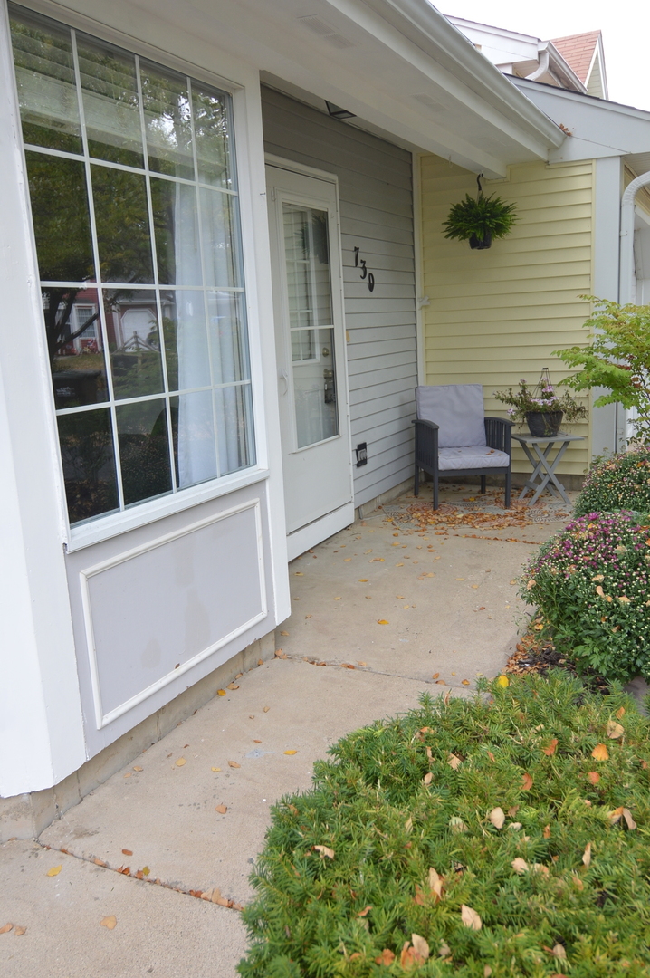 730 Nantucket Way Island Lake, IL 60042 - Photo 2 of 29 a backyard of a house with seating space and porch