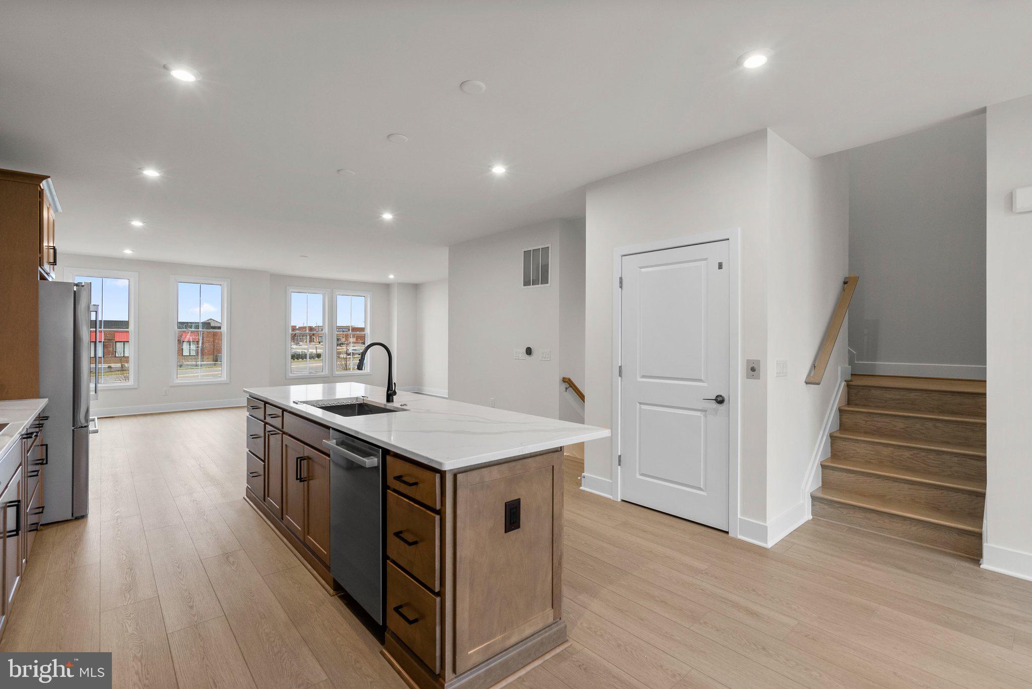 44480 Lowestoft Square Ashburn, VA 20147 - Photo 11 of 44 a kitchen with stainless steel appliances a stove a sink and a refrigerator