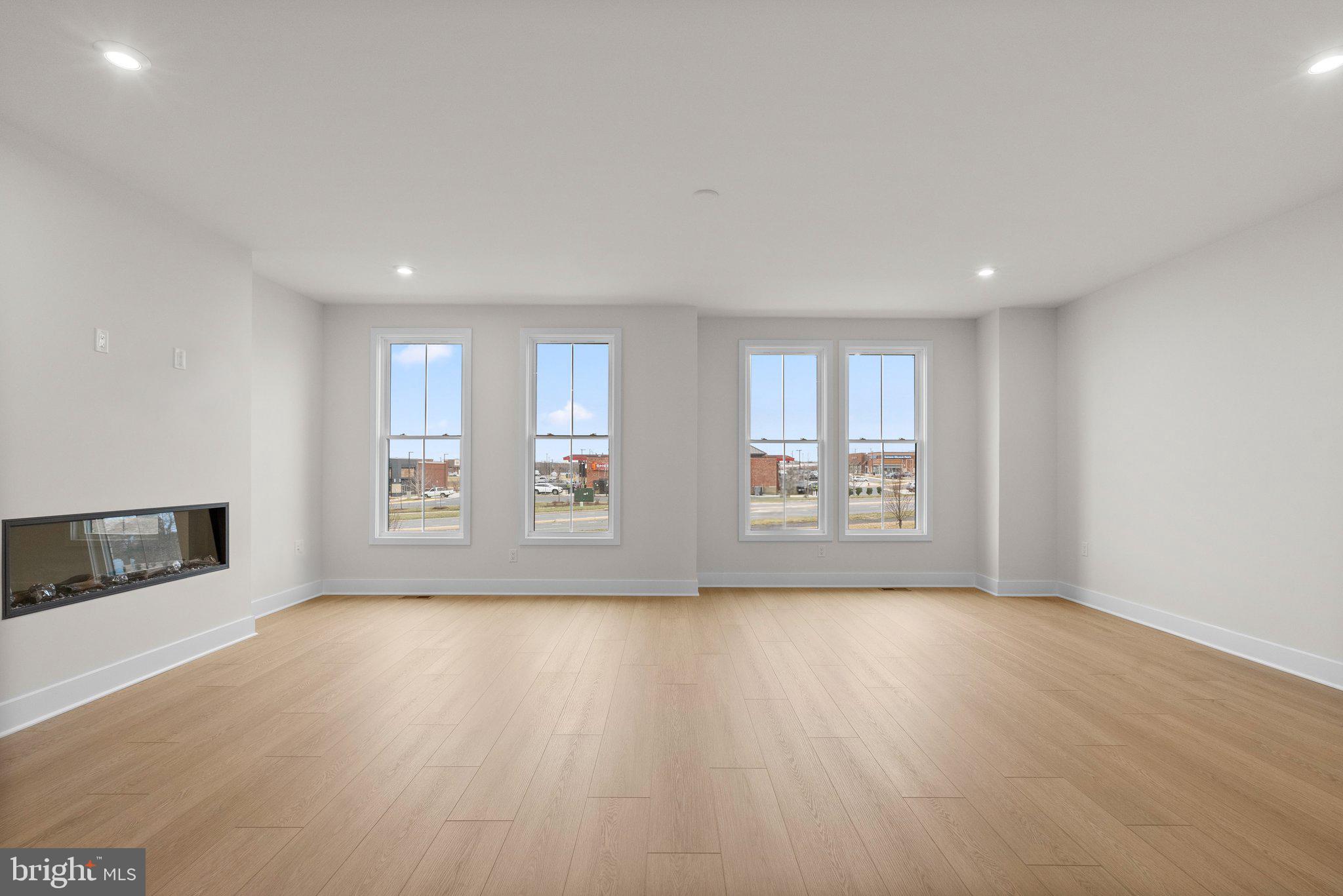 44480 Lowestoft Square Ashburn, VA 20147 - Photo 12 of 44 a view of an empty room with a window and wooden floor