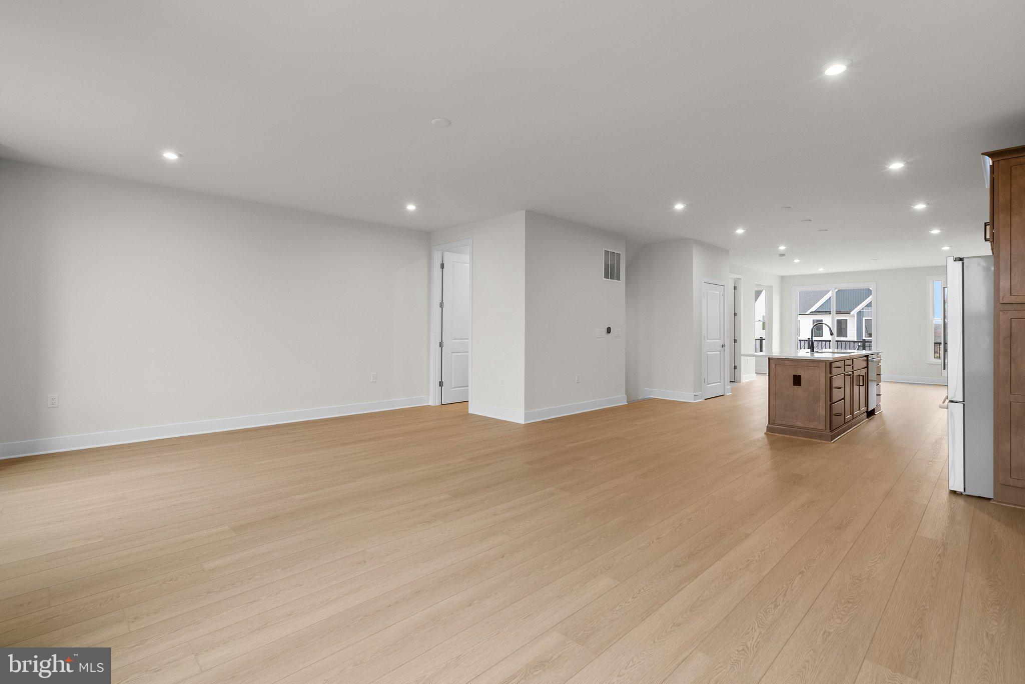 44480 Lowestoft Square Ashburn, VA 20147 - Photo 14 of 44 a view of kitchen with kitchen island wooden floor center island and stainless steel appliances