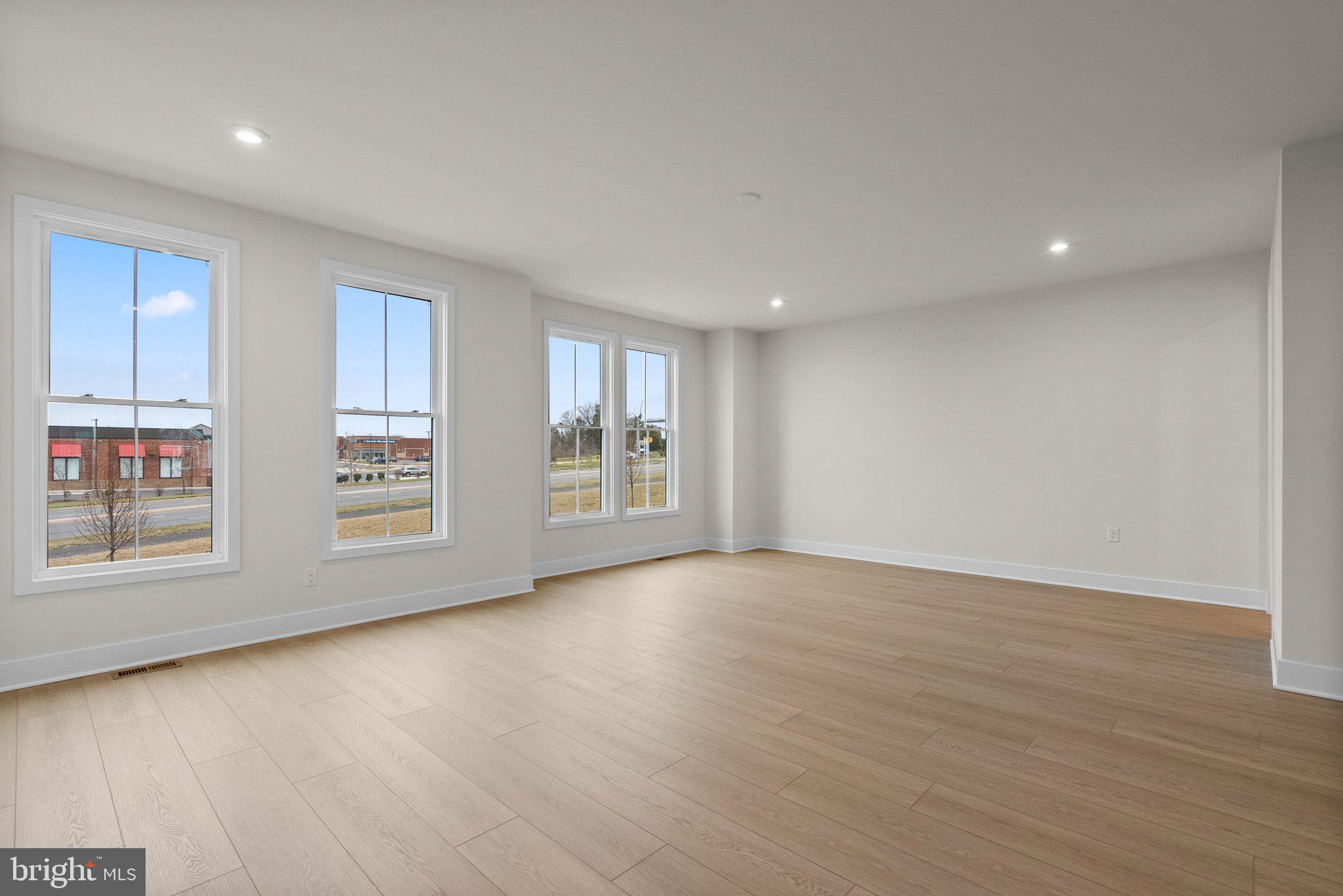 44480 Lowestoft Square Ashburn, VA 20147 - Photo 15 of 44 a view of an empty room with a window and wooden floor