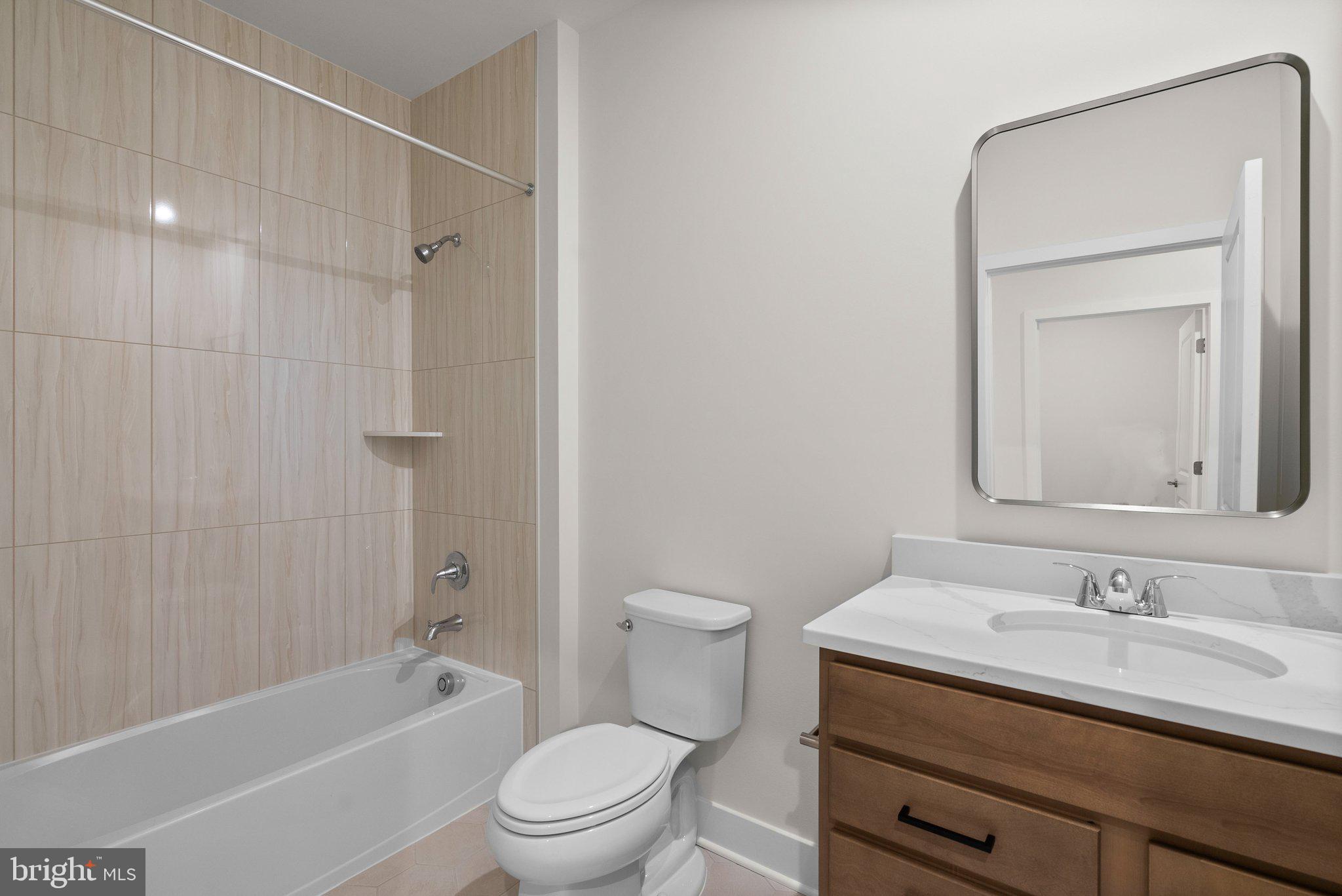 44480 Lowestoft Square Ashburn, VA 20147 - Photo 22 of 44 a bathroom with a granite countertop sink a toilet and shower