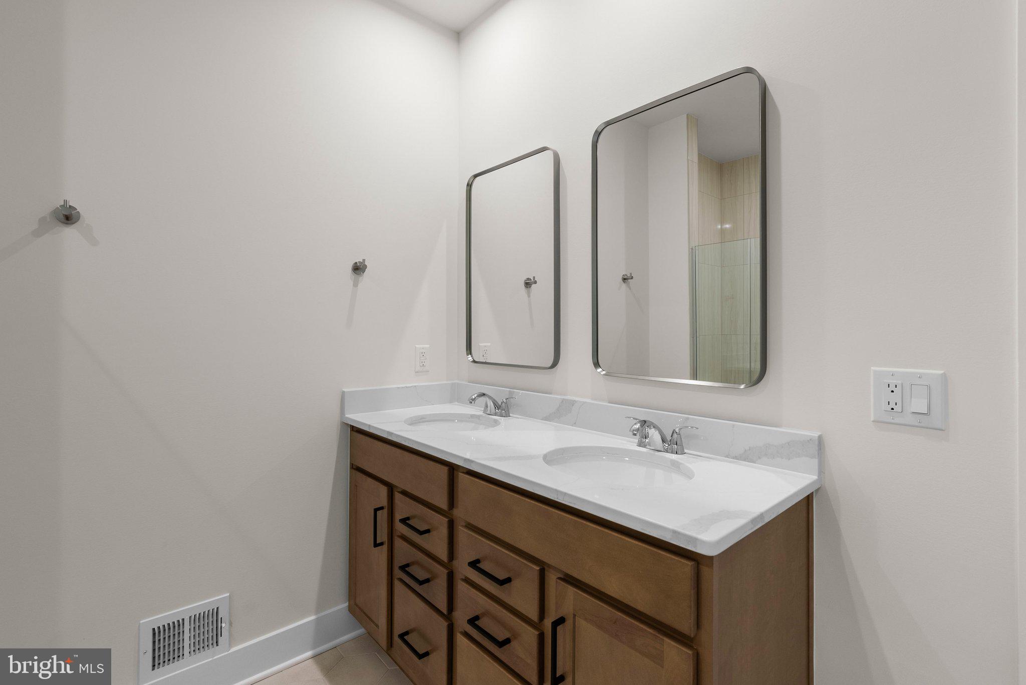 44480 Lowestoft Square Ashburn, VA 20147 - Photo 26 of 44 a bathroom with a sink and a mirror