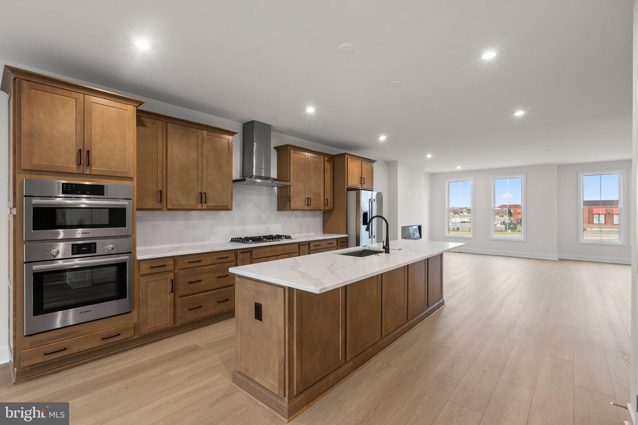 44480 Lowestoft Square Ashburn, VA 20147 - Photo 9 of 44 a large kitchen with stainless steel appliances granite countertop a large counter top a stove and a sink