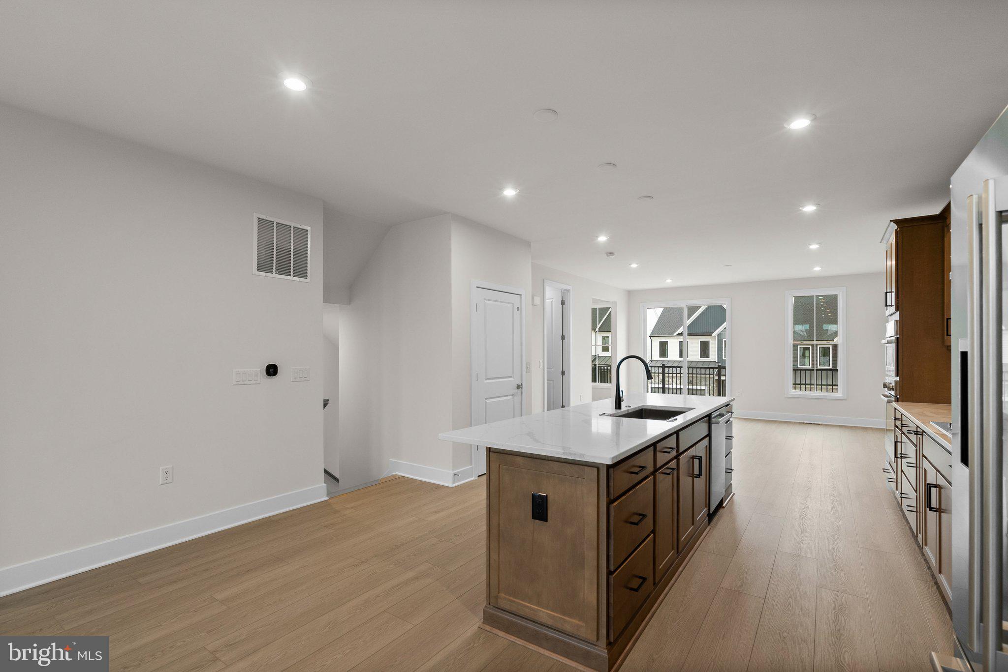 44480 Lowestoft Square Ashburn, VA 20147 - Photo 10 of 44 a kitchen with stainless steel appliances granite countertop a stove and a sink