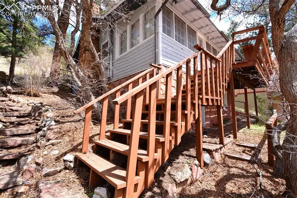 a view of building with wooden stairs and bench