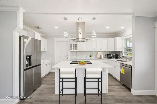 a kitchen with granite countertop a sink stainless steel appliances and cabinets