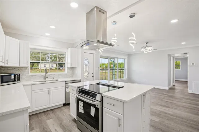 a kitchen with a stove a sink and a refrigerator