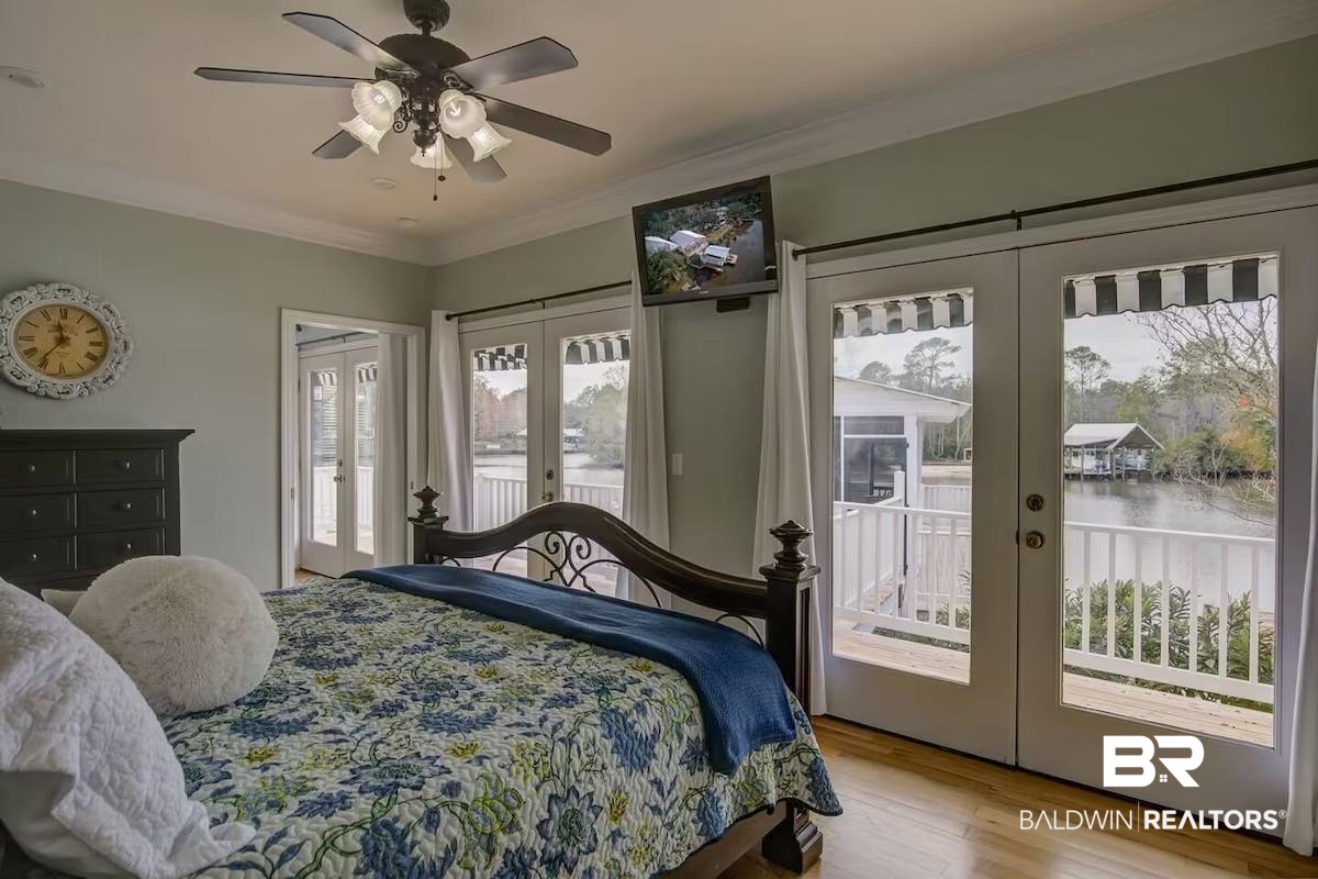 16297 Honey Road Summerdale, AL 36580 - Photo 16 of 24 Light-filled interior featuring wood-finish flooring, a ceiling fan with integrated lighting, and multiple sets of French doors