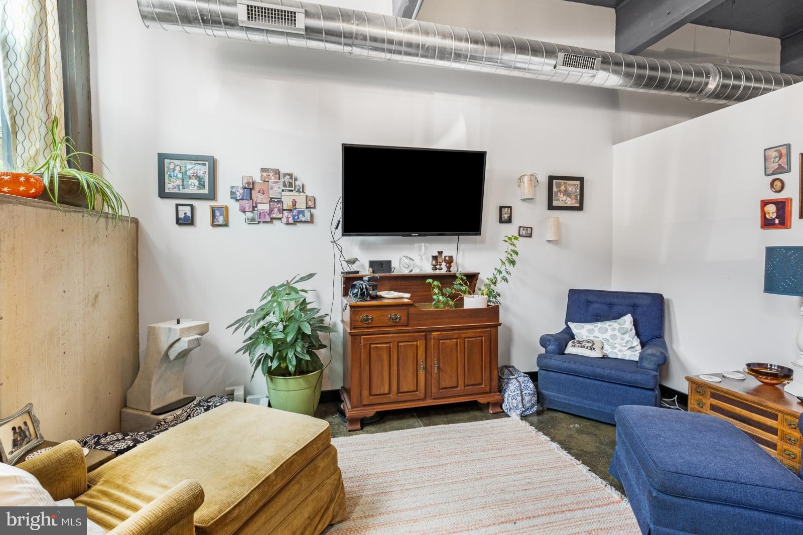 1701 Tulip Street, Unit LL2 Philadelphia, PA 19125 - Photo 3 of 27 a living room with furniture and a flat screen tv