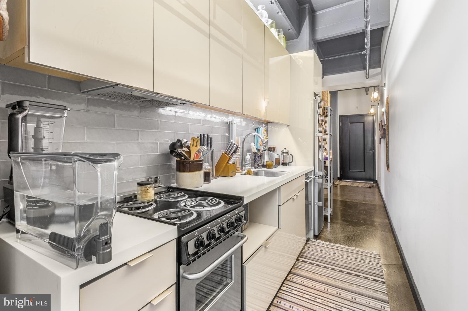 1701 Tulip Street, Unit LL2 Philadelphia, PA 19125 - Photo 8 of 27 a kitchen with stainless steel appliances granite countertop a stove and a cabinets