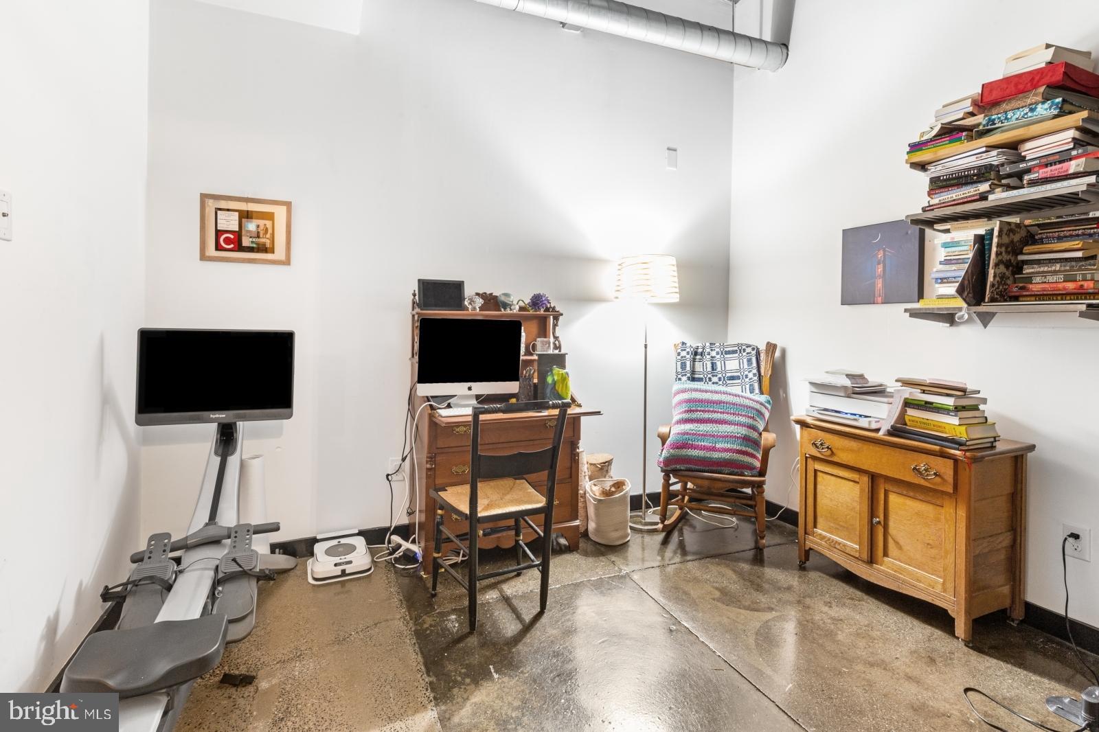 1701 Tulip Street, Unit LL2 Philadelphia, PA 19125 - Photo 10 of 27 a view of a workspace with furniture and a flat screen tv