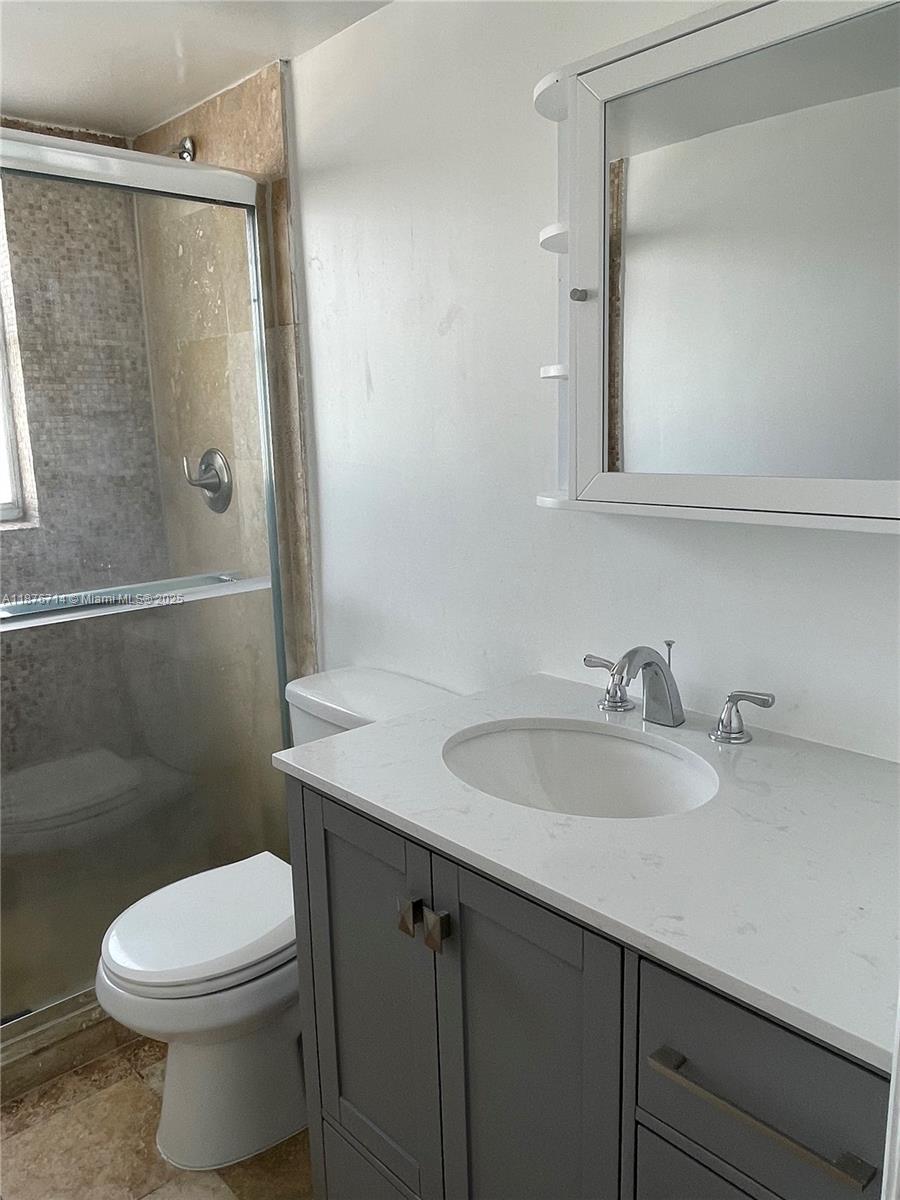 1881 Washington Avenue, Unit 15C Miami Beach, FL 33139 - Photo 15 of 30 a bathroom with a sink a toilet and shower