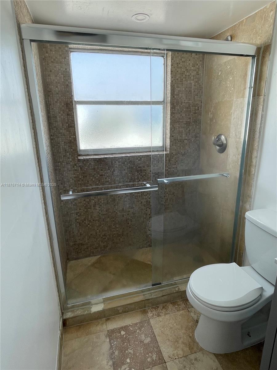 1881 Washington Avenue, Unit 15C Miami Beach, FL 33139 - Photo 16 of 30 a bathroom with a toilet and a shower