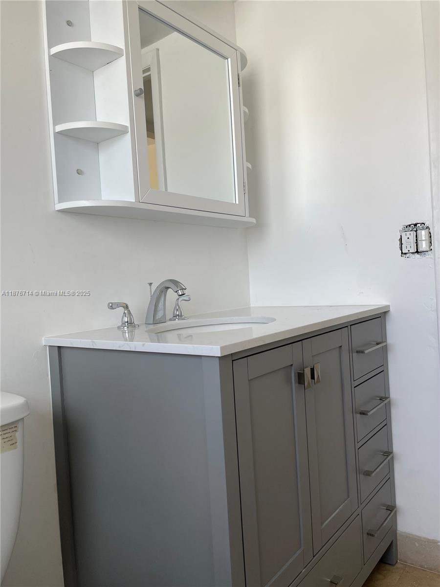 1881 Washington Avenue, Unit 15C Miami Beach, FL 33139 - Photo 17 of 30 a close view of two sink a mirror and cabinets