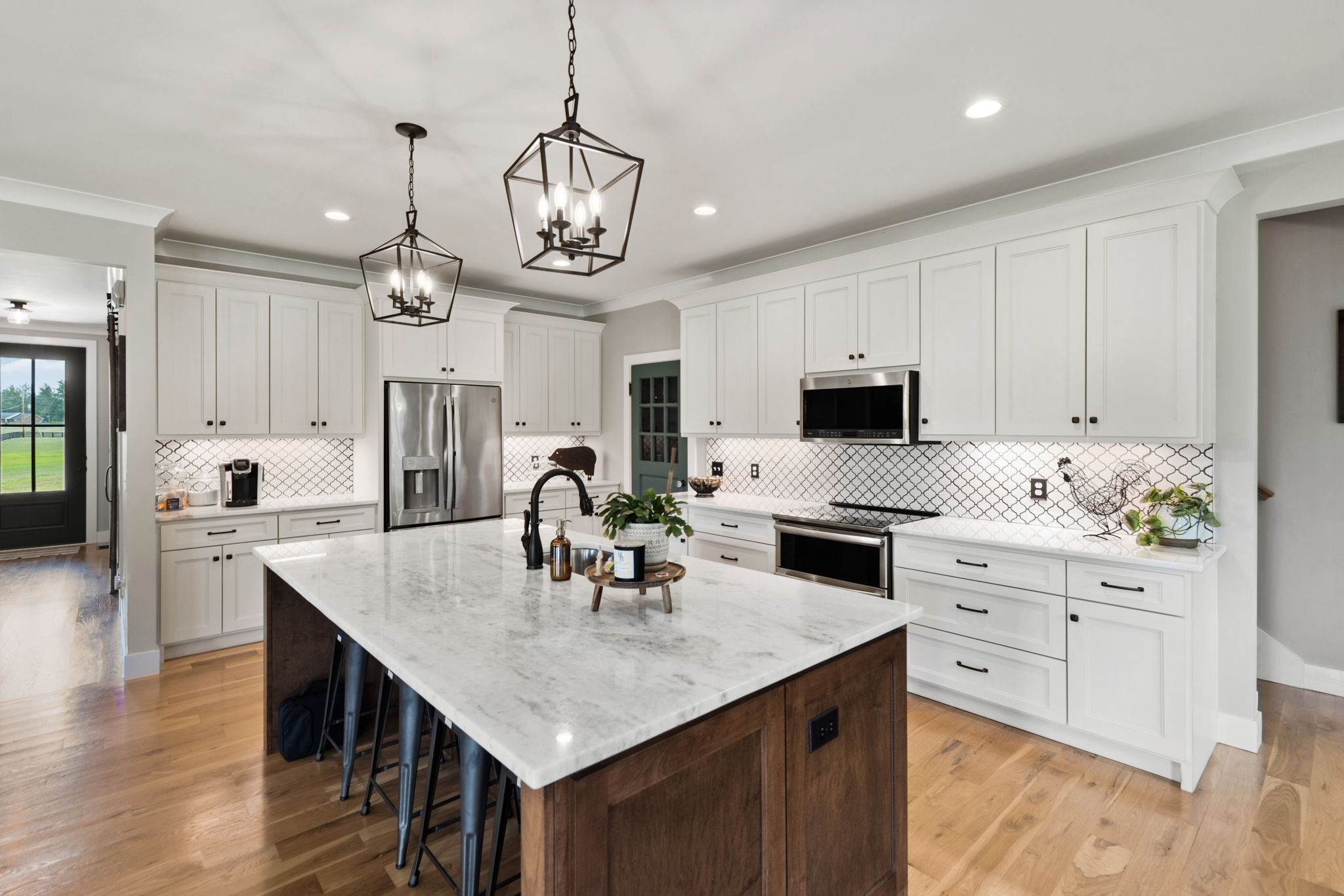5651 Flewellyn Road Springfield, TN 37172 - Photo 14 of 55 a kitchen with stainless steel appliances granite countertop a sink dishwasher and white cabinets with wooden floor