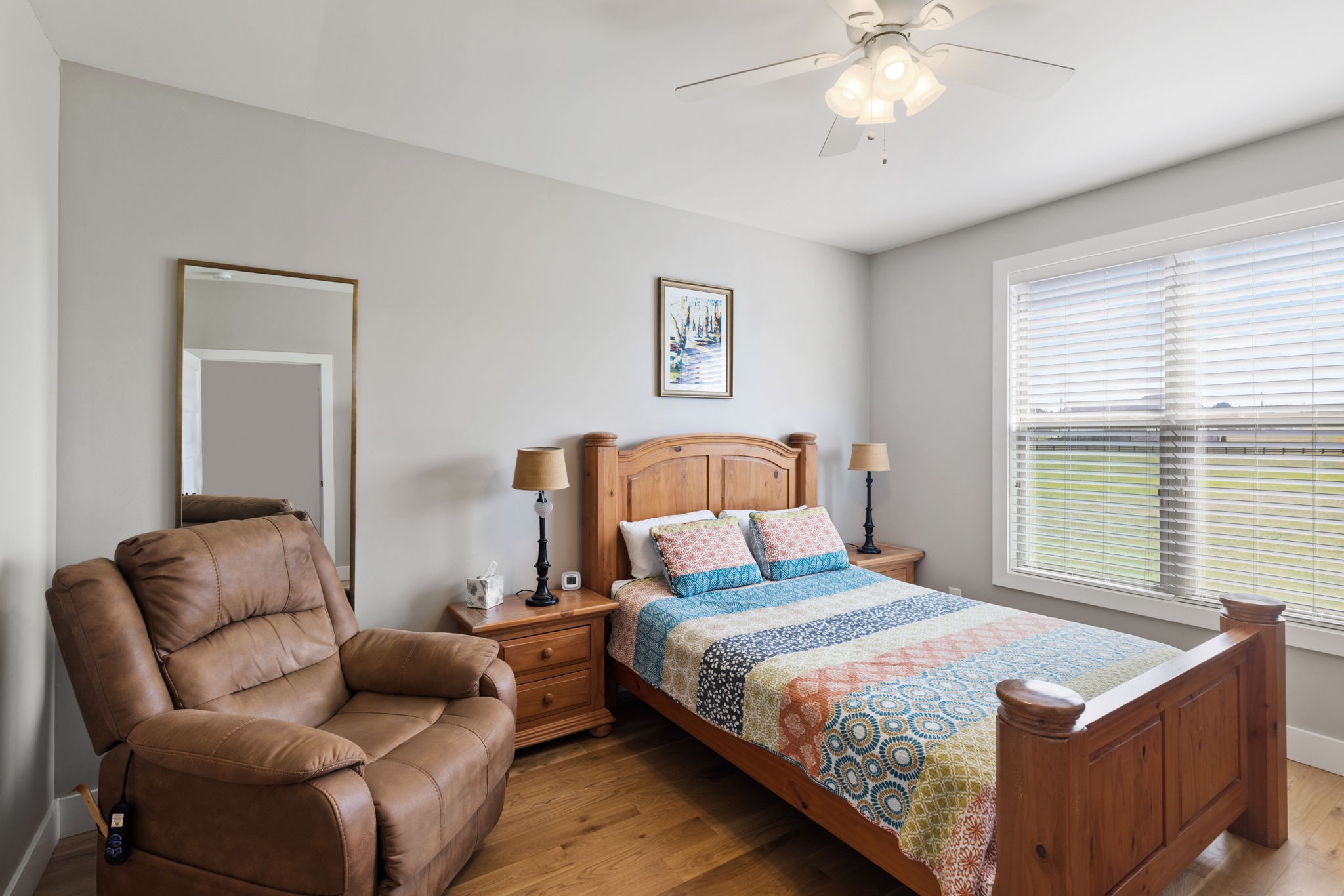 5651 Flewellyn Road Springfield, TN 37172 - Photo 29 of 55 a bedroom with a large bed and a chandelier