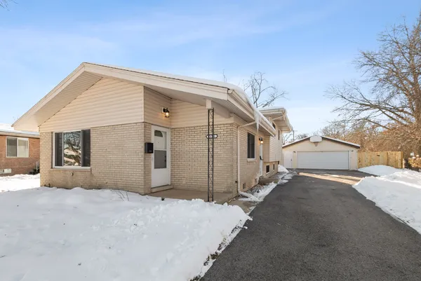 a view of a house with a snow in the yard