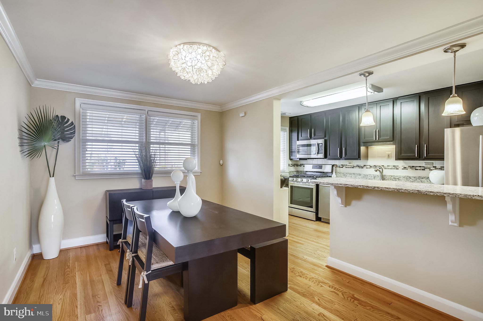 1409 Langford Road Baltimore, MD 21207 - Photo 12 of 39 a kitchen with a table and chairs in it