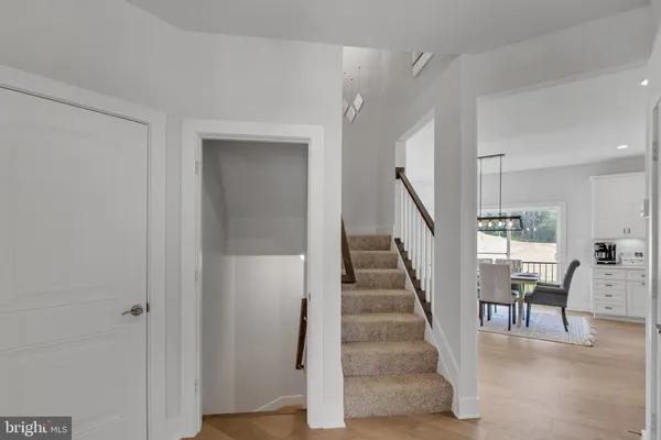 a view of entryway and dining room with wooden floor