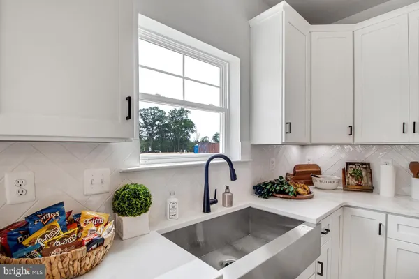 a kitchen with a sink cabinets and a window